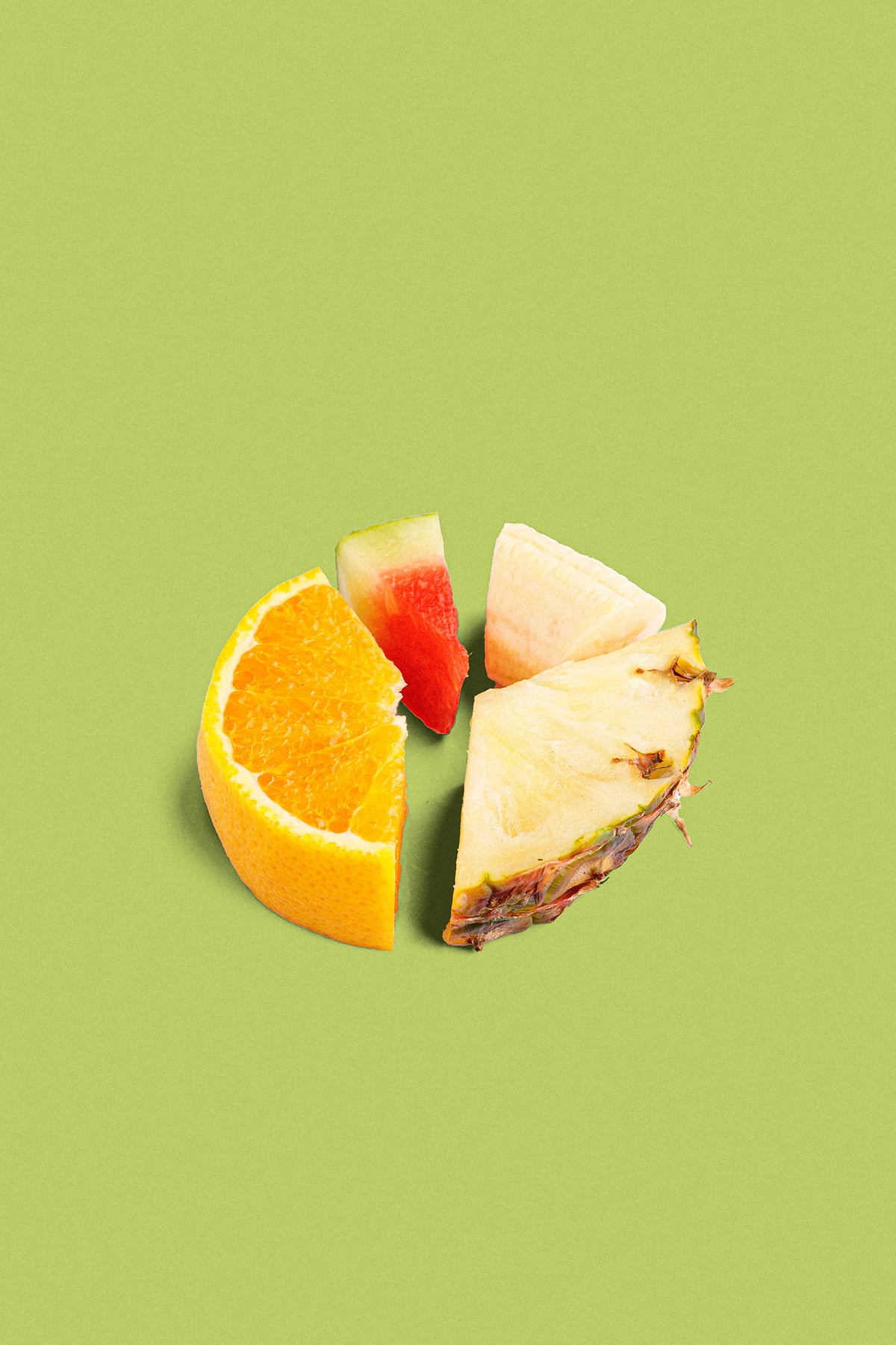 Sliced Fruits on Green Background